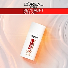 Флюїд з вітаміном С для захисту обличчя SPF 50 - L'Oreal Paris Revitalift Clinical SPF50+ Anti-UV Fluid — фото N9