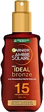 Солнцезащитное водостойкое масло-спрей "Идеальный загар" для кожи тела и лица, средняя степень защиты SPF15 - Garnier Ambre Solaire Ideal Bronze — фото N1
